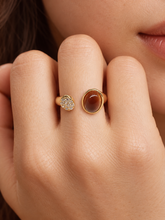 amber brown cat eye stone ring on hand