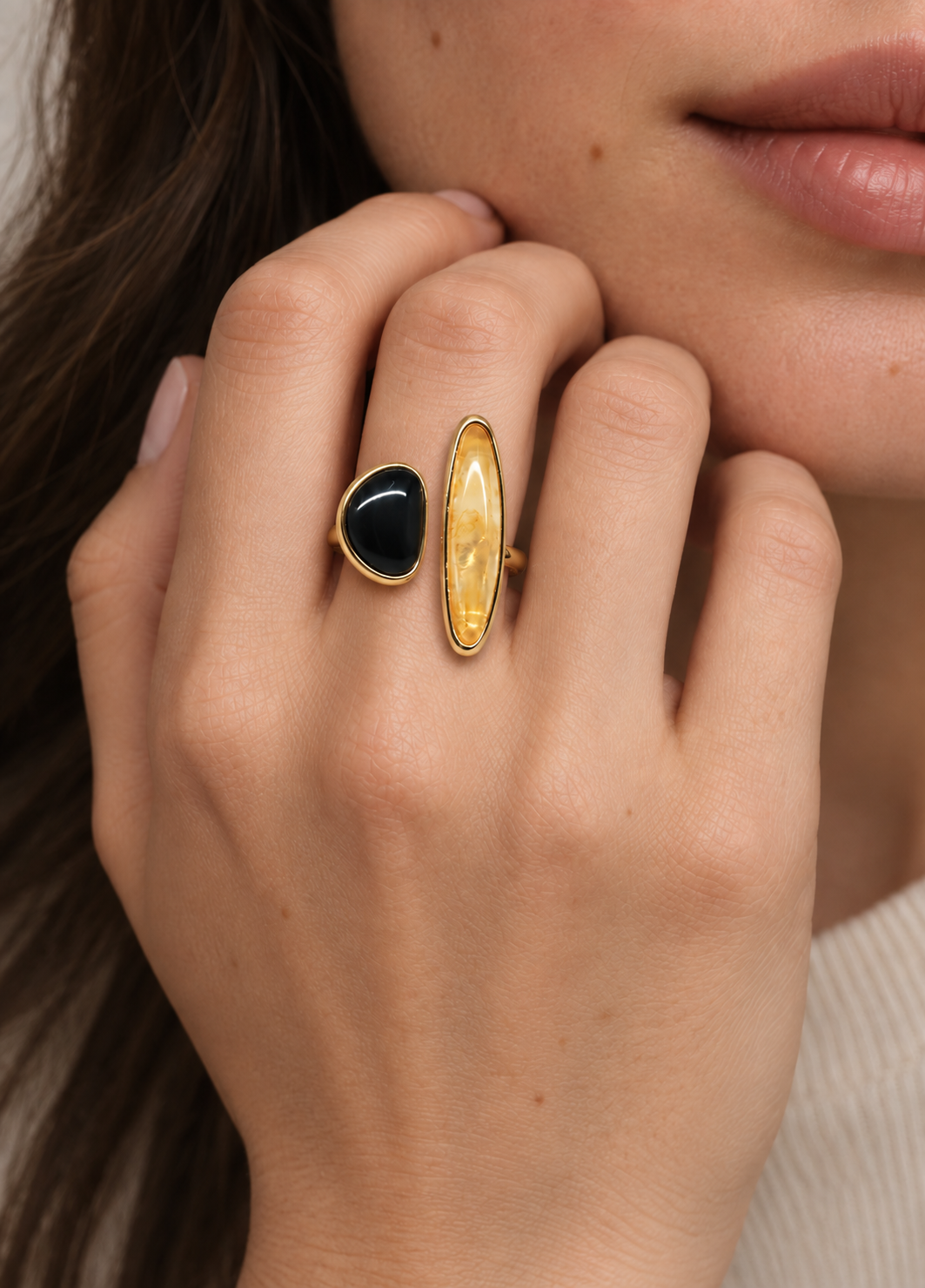 black stone sculptural ring on hand