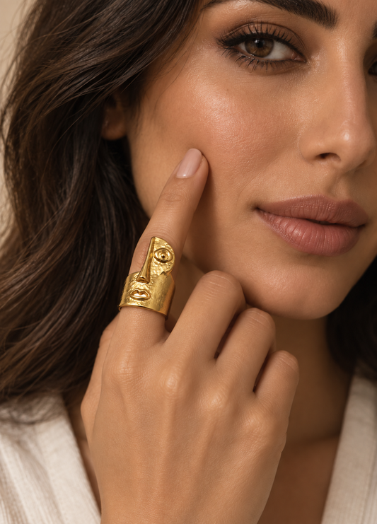 gold hammered abstract face statement ring on hand