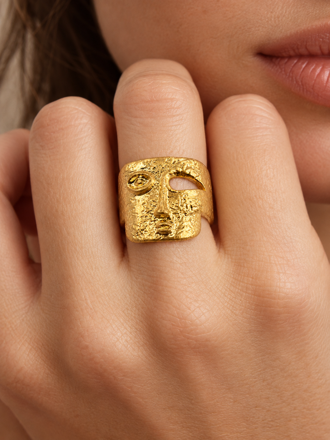 hammered gold statement ring on hand