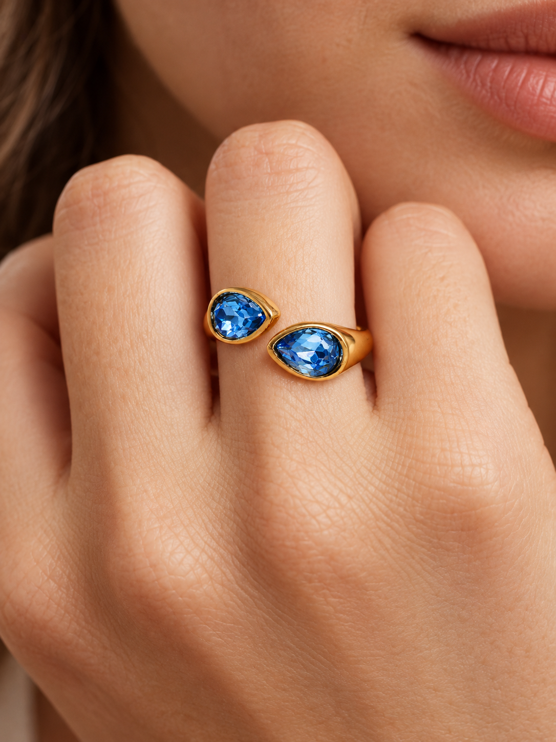 ocean blue teardrop bypass ring on hand