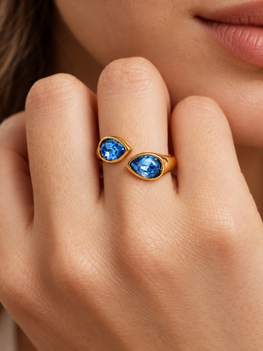 ocean blue teardrop bypass ring on hand