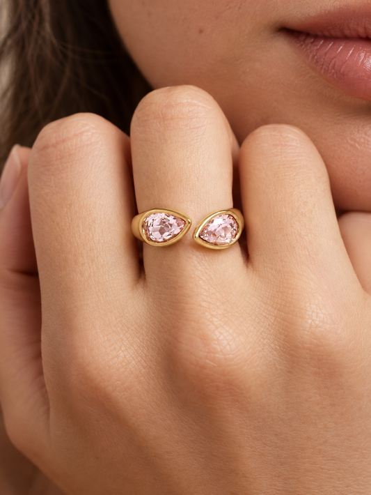 pink crystal bypass ring on hand