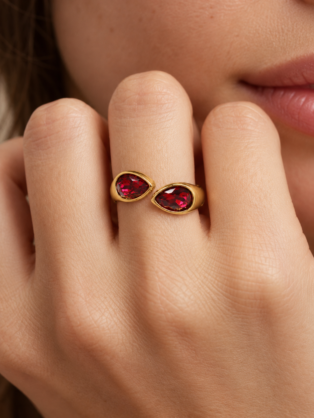 ruby red teardrop bypass ring on hand
